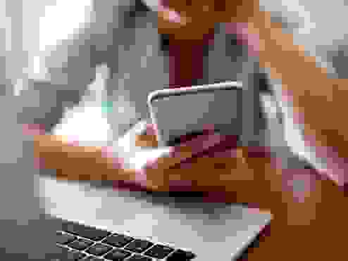 Woman using a Phone and laptop